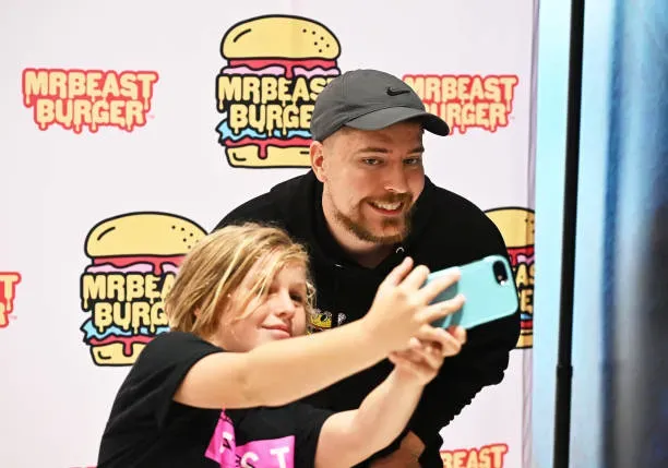 A contestant wanted to go through an escape room in order to win $100,000. An unnamed competitor trekked through multiple sets, including a room with spiked walls and a snake-infested jungle, in a quest to win $100,000 after Donaldson constructed the “world’s most dangerous escape room”. Karl Jacobs and Chris Tyson were involved in helping the contestant. In the end, the winning amount was $95,000, as the contestant agreed to give up $5,000 for a clue midway through the video. They won $240,000 for their fans, for doing things like tightrope-walking and wimming with sharks. Donaldson had a number of simultaneous challenges in his second video of the year. Tyson recovered a backpack full of $100,000 floating in shark-infested waters, with the prize money going to a fan. Arrack was offered $10,000 for every hour spent in a freezing room, with the prize. Donaldson gave away $40,000 to one contestant for doing nothing, and $20,000 to another for tightrope-walking across a chasm between two 1,000-foot canyons. Donaldson gave away over two hundred thousand dollars throughout the video. A man spent 22 days living alone in a basement to buy a ring for his girlfriend. Donaldson increased the prizes for his third video of the year, which saw a contestant named Josh being challenged to live in a basement-esque “prison” for as long as possible, earning $10,000 for every day spent there. Josh won a total of $340,000 thanks to some ancillary betting and a hidden $100,000 check at the end of his 22-day stay. Josh proposed to his girlfriend at the end of the video after using $20,000 of his prize money to purchase an engagement ring. MrBeast’s take on ‘Charlie and the Chocolate Factory’ resulted in a $600,000 prize. In one of Donaldson’s buzziest videos of the year, a parody of “Charlie and the Chocolate Factory,” 10 contestants were given the chance to win the factory he’d constructed to host the challenge or cash in the property. The last man standing at the end of a series of candy-themed challenges, which included a chocolate-eating contest, a bake-off, and a visit from Gordon Ramsey, was the YouTuber, who chose to take home a cash prize. The women’s team won $500,000 in a battle of the sexes that lasted for days. In a kind of battle of the sexes, Donaldson challenged 100 men and 100 women to remain in an enclosure for 100 hours, with the winning team taking home $500,000, or $5,000 for each team member. In addition to the $500,000, Donaldson also gave away two Nissan sedans, a box of Reese’s Puffs cereal, and tens of thousands of dollars. Subscribers of the channel had a chance to win a private island. On July 28, the MrBeast YouTube channel passed the 100 million subscribers mark and celebrated the achievement by giving 100 subscribers the chance to win a private island in a video posted on August 4.. The final 10 players were told to choose a plank that was above the water, five of which gave way and dropped them below, leaving five to compete in the last event. A race was held to find the MrBeast 100 million subscriber play button covered in the sand and earn one lucky winner the island. Donaldson and his crew hunted 100 people who hid in a mall in order to win a cash prize. Donaldson gave 100 subscribers $10,000 each in a silver briefcase and asked them to hide in one of the largest malls in the world for 10 hours. They were told they could keep the money after the time was up. A group of people in security uniforms joined the search and were offered a $60,000 bounty for the people they found. He said he’d buy a boat for their mothers if they helped find people, and brought on a group of people to help him. By the end of the video, 23 people were hidden and a combined $230,000 was given to the winners. Donaldson gave away at least $365,000 in this video which was viewed 66 million times. A subscriber was challenged to live in a red circle for 100 days and win a half a million dollars. Donaldson offered a check for $100,000 on the 50th day of the challenge, and on the 92nd day he offered a check for $1 million. The contestant won $500,000 after being watched by over 101 million viewers. Donaldson gave the cruise ship crew members an hour to win. Donaldson and his crew are staying in a variety of increasingly expensive hotel rooms around the world in a video that was posted on October 22. A $ 1-a-night mat and a 150,000-a-night hotel were included in the package. Donaldson said he rented a cruise ship for one hour, hid $100,000 in cheques around the ship, and gave the crew an hour to find the money. $40,000 was the total amount they received. YouTubers competed in an endurance challenge. A group of 11 YouTubers were told in a video posted on November 12 that the last to keep their hand on a $2.5 million jet would win it. They weren’t allowed to push someone to lose contact with the jet. The line-up included LazarBeam, who has over 20.3 million subscribers. Chunkz gave up his position in exchange for Donaldson’s card, which he said would “probably stop after 10 grand.” WroeToShaw won the challenge and the jet after 18 hours. Kids and adults went head to head in a competition for money. On December 3, Donaldson shared a video that showed 100 kids and 100 adults in two separate cubes, and told them that whichever building had the most people remaining after 100 hours would win the grand prize of $500,000, which would be split between the remaining players. One hour into the challenge, Donaldson told the contestants he would give them $1,000 if they left within 60 seconds and 22 people took him up on the offer. Two people were tricked into leaving as a briefcase with $1 stuck out was left by the door, but it turned out to be empty when opened. The adults won the task and were given half a million dollars to share between the remaining 49 people, after one adult accidentally crossed the line with one hour remaining in the challenge. This brought the total amount of money given away to over half a million dollars.
